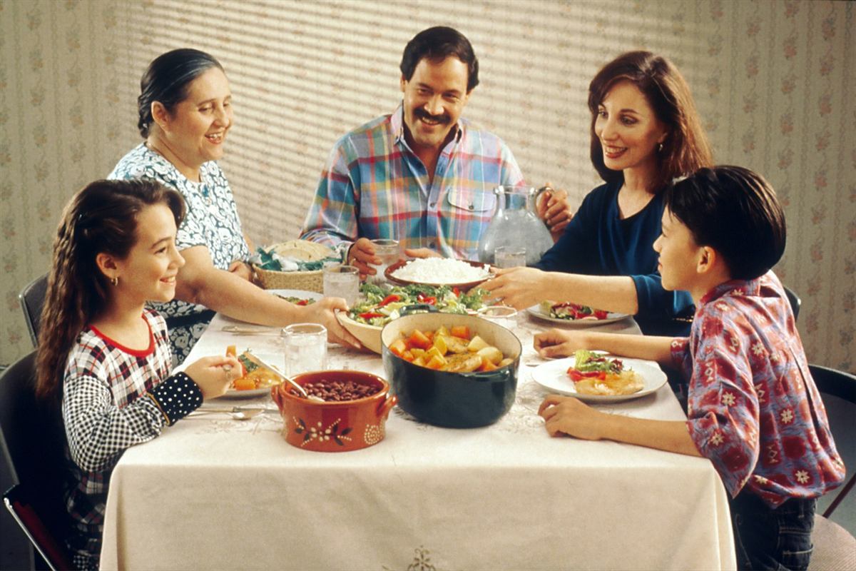 A family of three generations sharing a meal around the dinner table